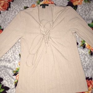 Ripped long sleeve shirt with tie up front.